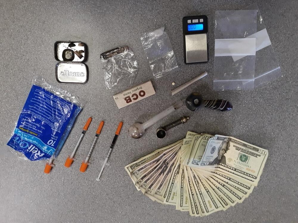 Photo of alleged meth and plastic bags, syringes, and cash money.