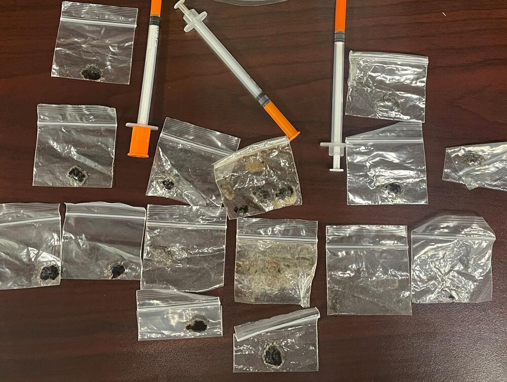 Photo of alleged packages of heroin and some syringes.