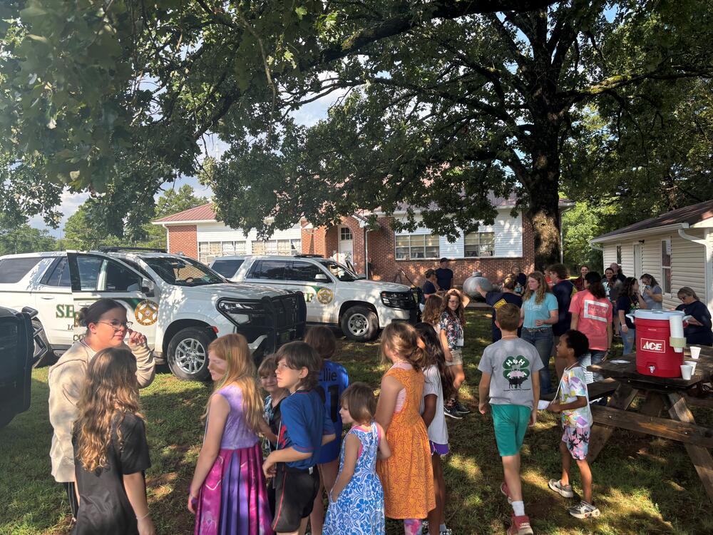 Photo of Sheriff Vehicles and kids at church.